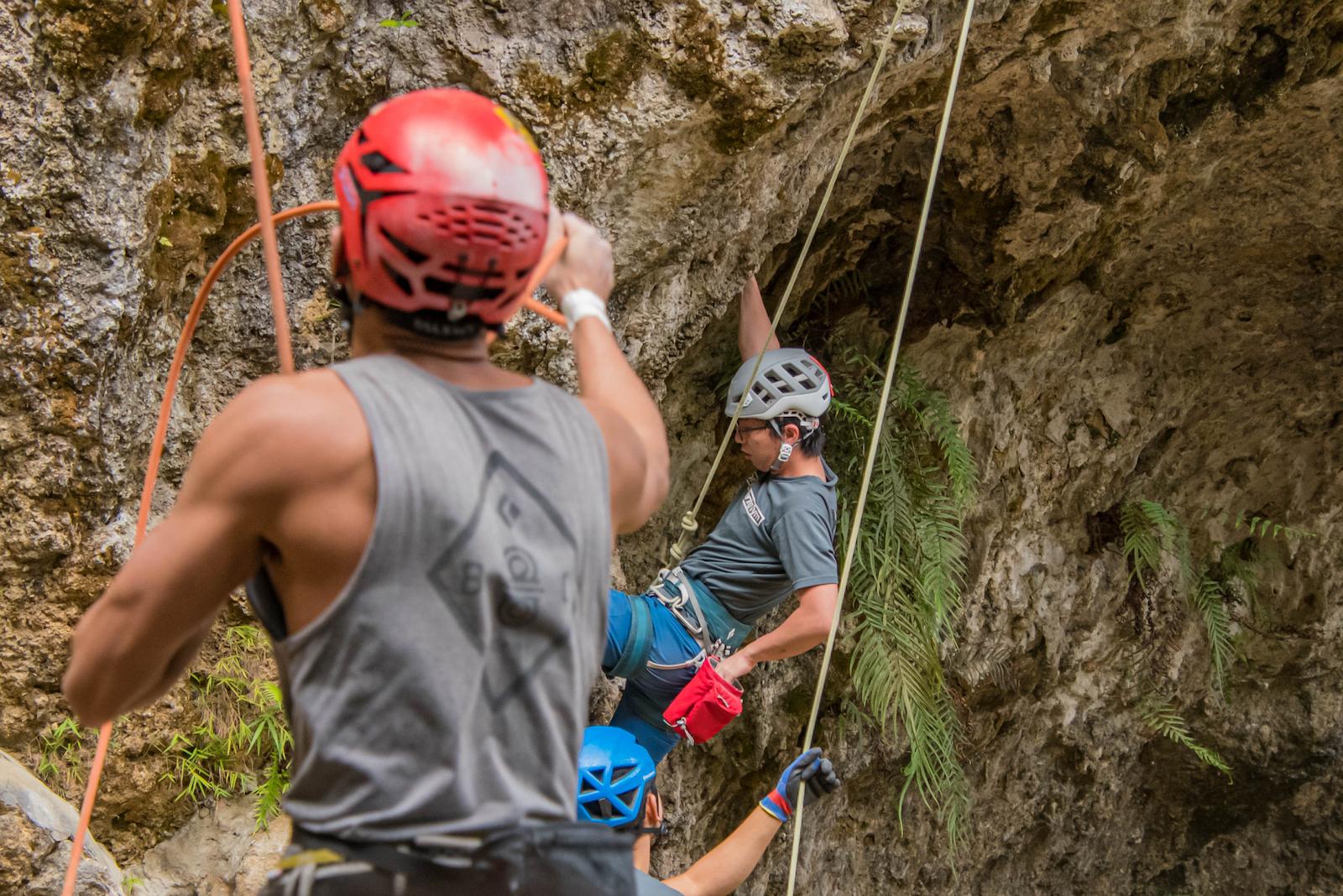 Climber bouldering indoors